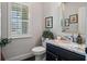 Stylish powder room featuring a granite countertop, dark vanity, and decorative mirror at 452 Rockford Pass, Marietta, GA 30064