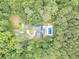 Aerial view of home and pool surrounded by dense, mature trees at 1667 Quail Run, Conyers, GA 30094