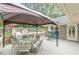Inviting back deck with shaded seating area, perfect for outdoor dining and relaxing by the pool at 1667 Quail Run, Conyers, GA 30094