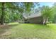 Expansive backyard featuring a lush green lawn, wooden deck and mature trees at 1667 Quail Run, Conyers, GA 30094
