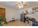 Neutral bedroom showcasing wood-look flooring, ceiling fan, secure safe, deer head and eclectic decor at 1667 Quail Run, Conyers, GA 30094