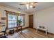 Bright bedroom featuring wood-look flooring, a ceiling fan, natural light, and a decorative window treatment at 1667 Quail Run, Conyers, GA 30094