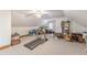 The bonus room has a treadmill, desk, storage, and a ceiling fan at 1667 Quail Run, Conyers, GA 30094