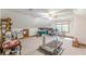A large bonus room with a treadmill, desk, rocking chair, and ample space at 1667 Quail Run, Conyers, GA 30094