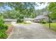 Charming home featuring a lush lawn, long driveway, and detached garage for convenience and curb appeal at 1667 Quail Run, Conyers, GA 30094