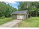 A single-car detached garage offers convenience and storage space within a serene, wooded setting at 1667 Quail Run, Conyers, GA 30094