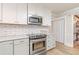 Modern kitchen with stainless steel appliances, white cabinets, and white subway tile backsplash at 1667 Quail Run, Conyers, GA 30094