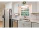 Bright kitchen featuring white cabinets, stainless steel appliances and subway tile backsplash at 1667 Quail Run, Conyers, GA 30094