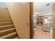 View of the living room and staircase; the living room has a fireplace and wood flooring at 1667 Quail Run, Conyers, GA 30094
