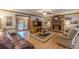 Inviting living area featuring a brick fireplace, hardwood flooring, and comfortable seating arrangements at 1667 Quail Run, Conyers, GA 30094