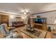 Open-concept living space with hardwood floors, a large TV, and ample seating for comfortable living at 1667 Quail Run, Conyers, GA 30094