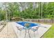 Beautiful in-ground pool and diving board surrounded by a concrete patio, landscaping, and wooden fence at 1667 Quail Run, Conyers, GA 30094