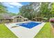 Gorgeous backyard with in-ground pool, diving board, surrounding patio, lush lawn, and mature trees at 1667 Quail Run, Conyers, GA 30094