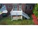 Brick home featuring a raised deck, with stair access to the manicured back yard at 1711 Summit Glen Ln, Atlanta, GA 30329