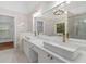 Luxurious bathroom featuring dual sinks, marble counters, modern fixtures and a large soaking tub at 1711 Summit Glen Ln, Atlanta, GA 30329