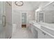 Bathroom featuring dual sink vanity, large soaking tub, and glass shower at 1711 Summit Glen Ln, Atlanta, GA 30329