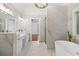 Bright bathroom featuring marble tile, walk in shower, and modern gold fixtures at 1711 Summit Glen Ln, Atlanta, GA 30329