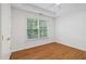 Bedroom featuring hardwood floors, neutral paint, and a large window at 1711 Summit Glen Ln, Atlanta, GA 30329