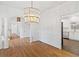Open-concept dining room with hardwood floors, decorative columns, and a modern chandelier at 1711 Summit Glen Ln, Atlanta, GA 30329