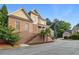 Charming brick home featuring a stone accent, landscaped front yard and a welcoming entrance with stairs at 1711 Summit Glen Ln, Atlanta, GA 30329