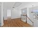 Upstairs hallway with hardwood floors leading to another room at 1711 Summit Glen Ln, Atlanta, GA 30329