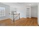 Hallway with hardwood floors, white trim, and access to different rooms at 1711 Summit Glen Ln, Atlanta, GA 30329