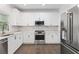 Modern kitchen featuring white cabinets, stainless steel appliances, and tile flooring at 1711 Summit Glen Ln, Atlanta, GA 30329