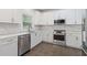 Well-lit kitchen with white cabinets, stainless steel appliances, and stylish countertops at 1711 Summit Glen Ln, Atlanta, GA 30329