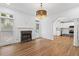Bright living room with hardwood floors, a fireplace, large windows, and a doorway to the kitchen at 1711 Summit Glen Ln, Atlanta, GA 30329