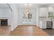Spacious open concept with hardwood floors, a fireplace, a dining area and a modern kitchen at 1711 Summit Glen Ln, Atlanta, GA 30329