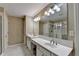 Bright bathroom featuring double vanity sinks, a large mirror, and a glass-enclosed shower at 2515 Gadsen Walk, Duluth, GA 30097