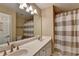 Bathroom with a double vanity and a shower with striped curtain at 2515 Gadsen Walk, Duluth, GA 30097