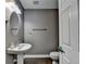 Powder room featuring modern fixtures and a pedestal sink set against a gray painted wall at 2515 Gadsen Walk, Duluth, GA 30097