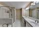 Well-lit bathroom featuring double sinks, a separate shower, and a luxurious soaking tub at 2515 Gadsen Walk, Duluth, GA 30097