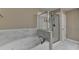 Bathroom featuring a relaxing soaking tub and a separate glass-enclosed shower at 2515 Gadsen Walk, Duluth, GA 30097