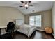 Well-lit bedroom with ceiling fan, desk area and hardwood floors at 2515 Gadsen Walk, Duluth, GA 30097