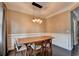 Dining room with hardwood floors, neutral walls, elegant lighting, and white trim at 2515 Gadsen Walk, Duluth, GA 30097