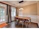 Bright dining room with hardwood floors, elegant lighting, and view to the exterior patio and backyard at 2515 Gadsen Walk, Duluth, GA 30097