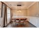Bright dining room with hardwood floors, elegant lighting, and neutral tan walls at 2515 Gadsen Walk, Duluth, GA 30097