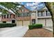 Charming brick townhome with a two-car garage and well-maintained landscaping at 2515 Gadsen Walk, Duluth, GA 30097