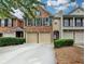 Charming brick townhome with a two-car garage and well-maintained landscaping at 2515 Gadsen Walk, Duluth, GA 30097