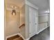 Hallway area with wooden staircase, carpet, and light fixture at 2515 Gadsen Walk, Duluth, GA 30097