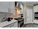 Modern kitchen featuring a stainless steel gas range and white cabinets at 2515 Gadsen Walk, Duluth, GA 30097