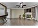 Open-concept living room with dark hardwood floors, fireplace, and seamless access to the kitchen at 2515 Gadsen Walk, Duluth, GA 30097