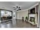 Open living room with fireplace flows into the kitchen's breakfast bar with modern dark hardwood floors at 2515 Gadsen Walk, Duluth, GA 30097