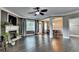 Spacious living room boasting dark hardwood floors, fireplace, and open access to dining area at 2515 Gadsen Walk, Duluth, GA 30097