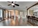 Open concept living and dining area with kitchen counter seating, and hardwood floors at 2515 Gadsen Walk, Duluth, GA 30097
