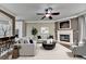 Cozy living room with neutral paint, fireplace, ceiling fan, and comfortable gray furniture at 2515 Gadsen Walk, Duluth, GA 30097
