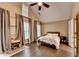 Primary bedroom with vaulted ceiling, many windows, neutral walls, and hardwood floors at 2515 Gadsen Walk, Duluth, GA 30097