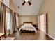 Primary bedroom with vaulted ceiling, many windows, neutral walls, hardwood floors, and ensuite bathroom at 2515 Gadsen Walk, Duluth, GA 30097